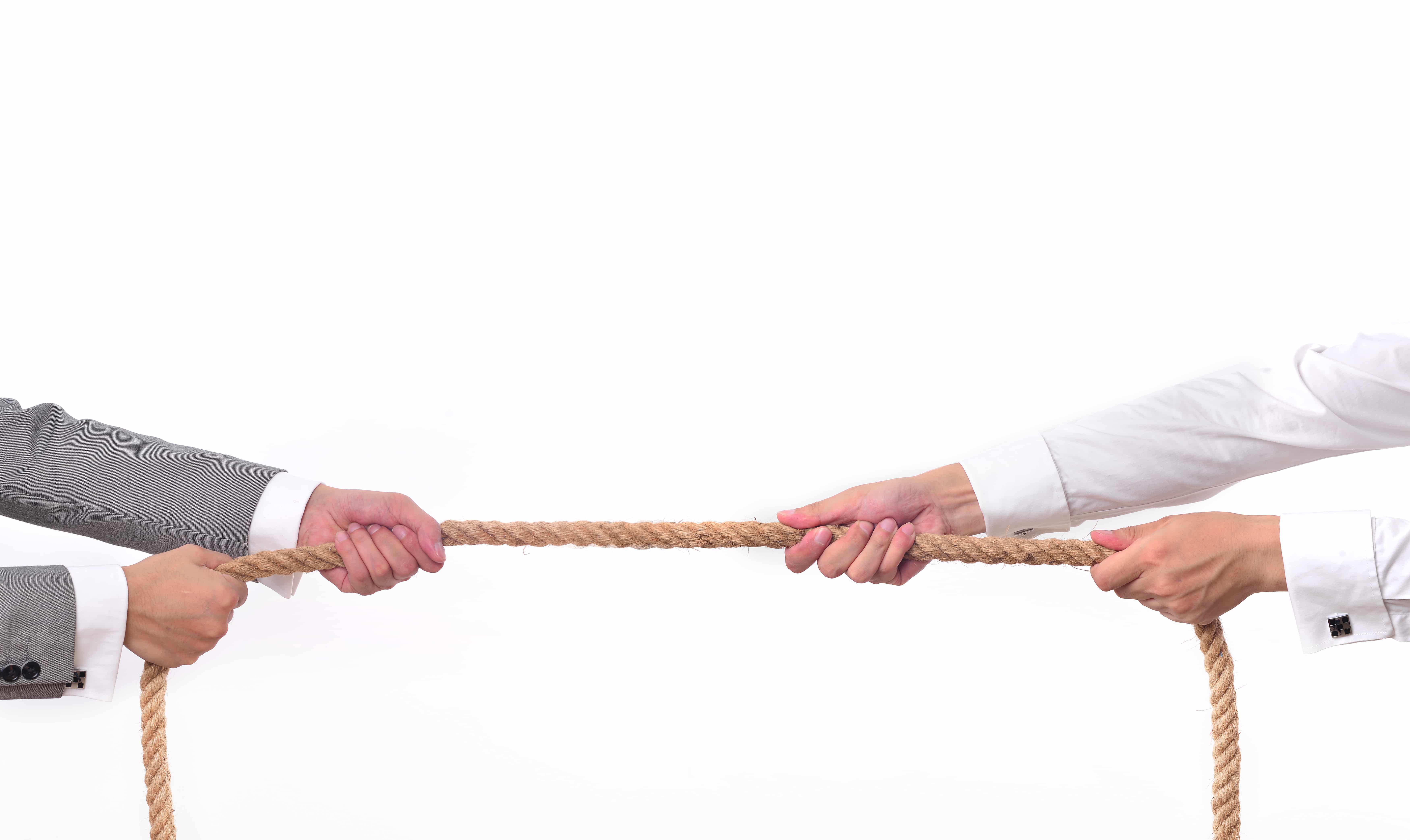 Tug war, two businessman pulling a rope in opposite directions isolated on white background
